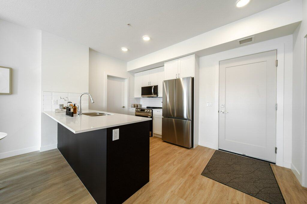 Kitchen of a two bed + den suite at Three Robins Riverside, independent senior living in St. Albert
