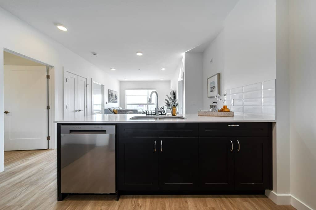 Kitchen of a two bed + den suite at Three Robins Riverside, independent senior living in St. Albert