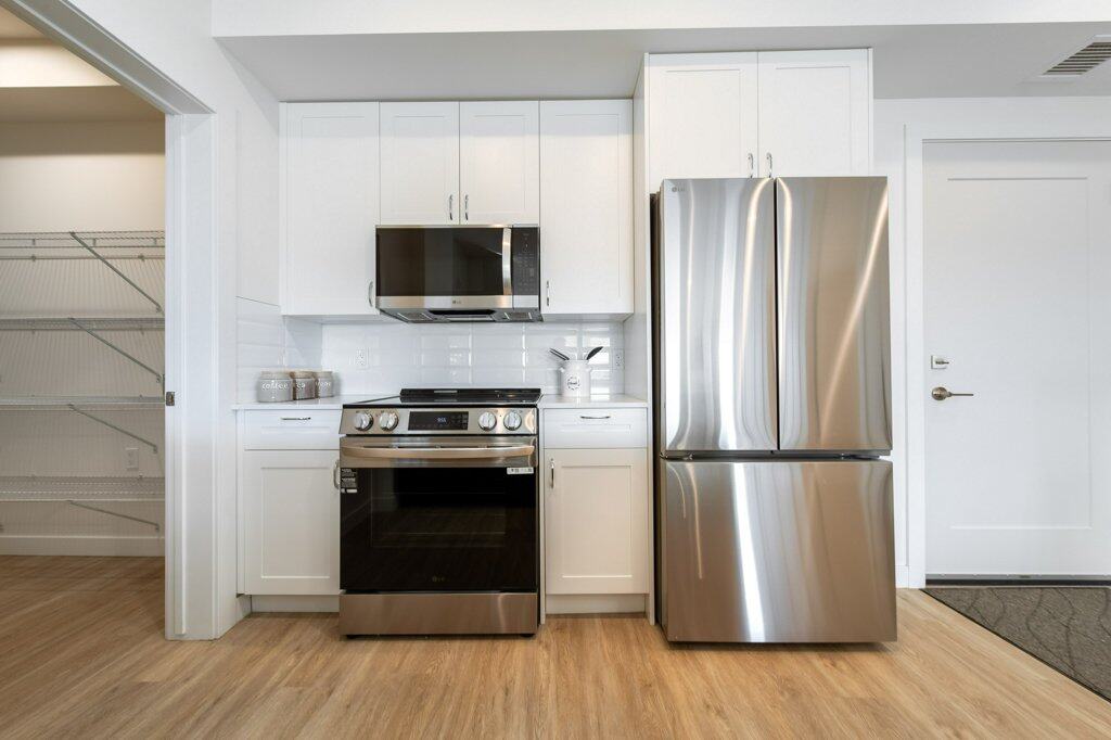 Kitchen of a two bed + den suite at Three Robins Riverside, independent senior living in St. Albert