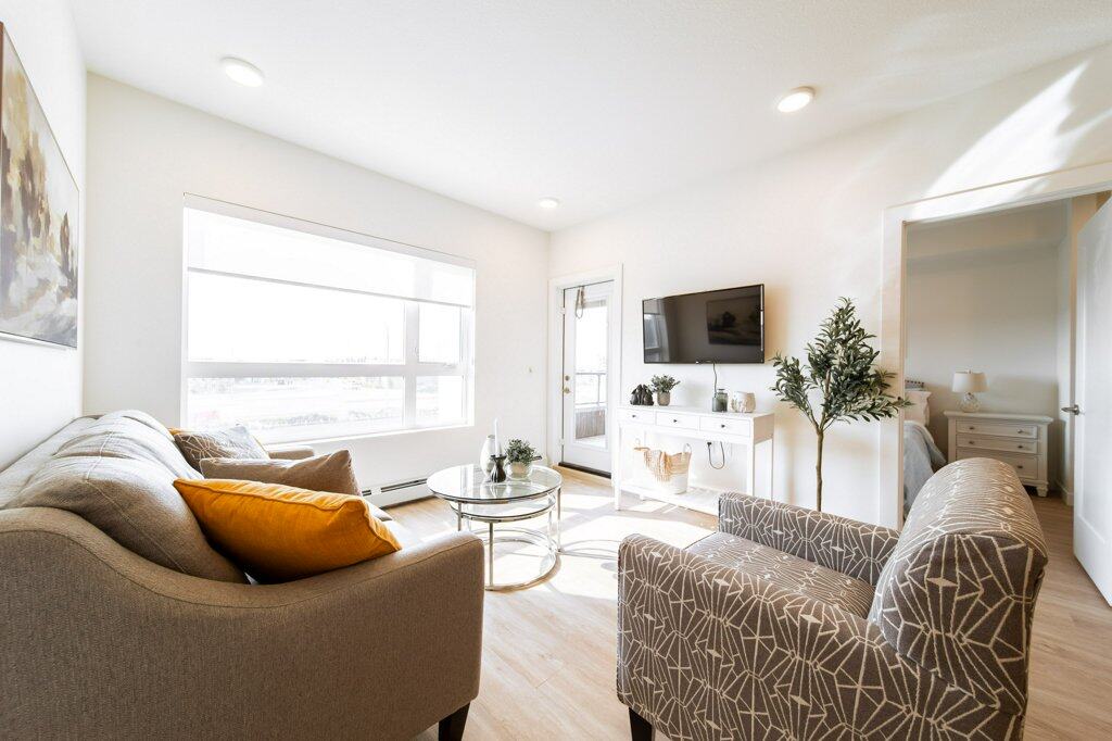 Living Room of a two bed + den suite at Three Robins Riverside, independent senior living in St. Albert