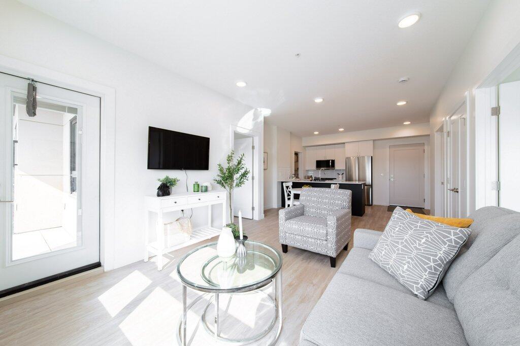 Living Room of a two bed + den suite at Three Robins Riverside, independent senior living in St. Albert