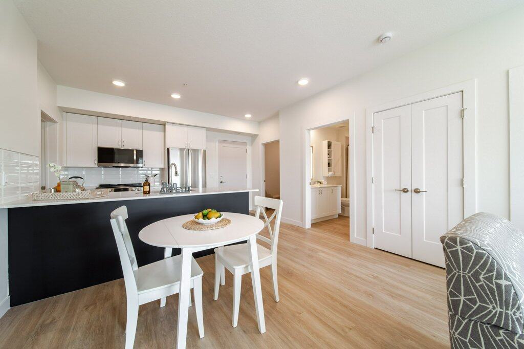 Dining Room of a two bed + den suite at Three Robins Riverside, independent senior living in St. Albert