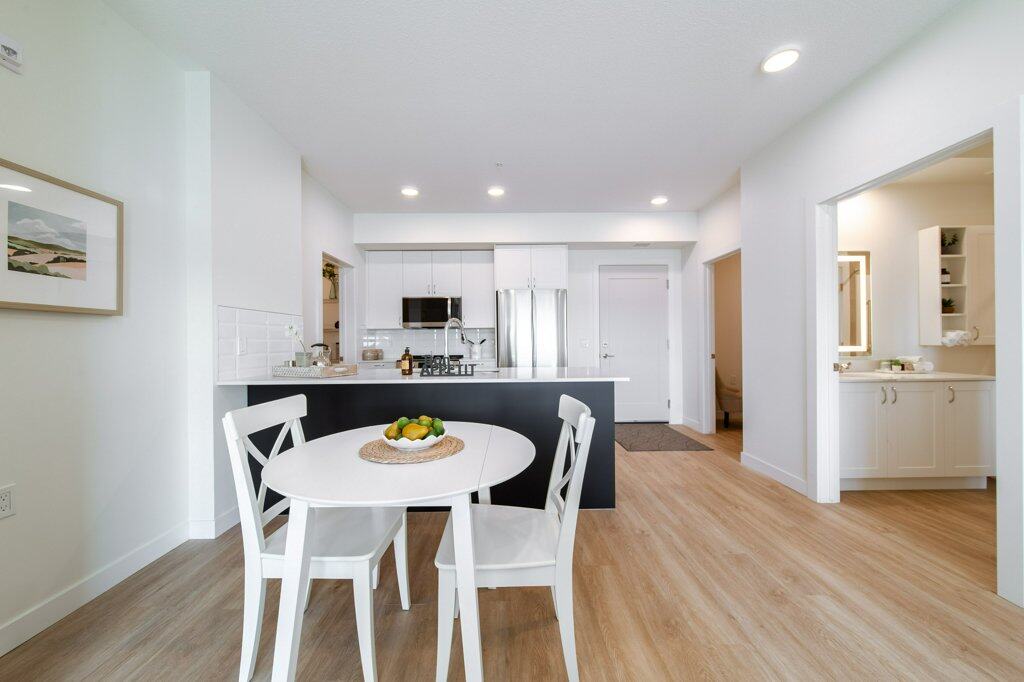 Dining Room of a two bed + den suite at Three Robins Riverside, independent senior living in St. Albert