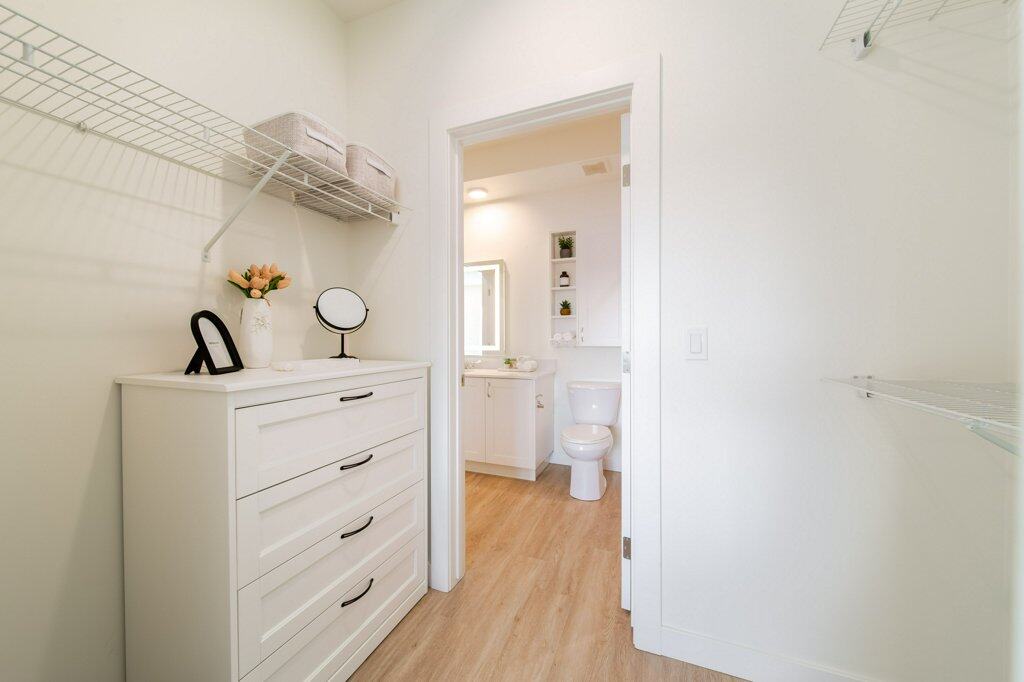 Walk-in closet in a suite at Three Robins Riverside, independent senior living in St. Albert