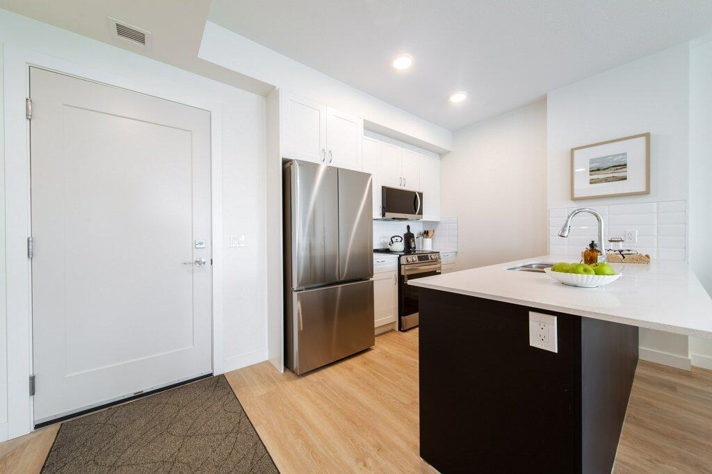 Kitchen in a two-bedroom suite at Three Robins Riverside, independent senior living in St. Albert