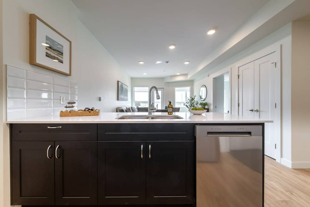 Kitchen in a two-bedroom suite at Three Robins Riverside, independent senior living in St. Albert