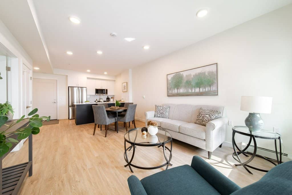 Living area in a two-bedroom suite at Three Robins Riverside, independent senior living in St. Albert
