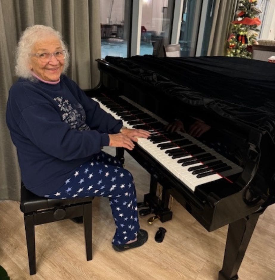 Patricia, a resident, brings music to Three Robins Riverside Community playing the piano