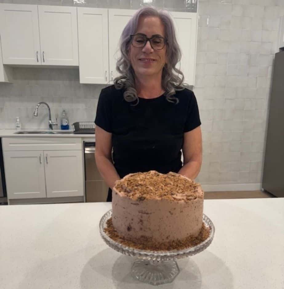 Three Robins resident showing her Skor cake baked in the community kitchen