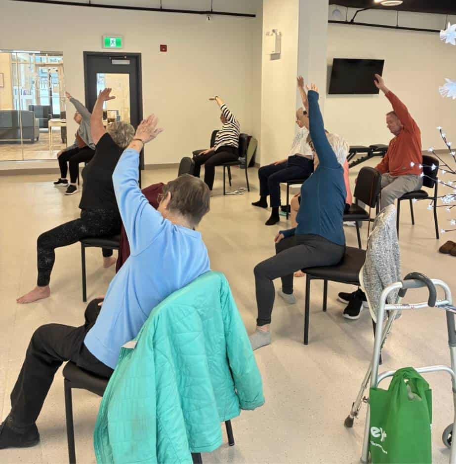 Group practicing chair yoga exercises at Three Robins Riverside