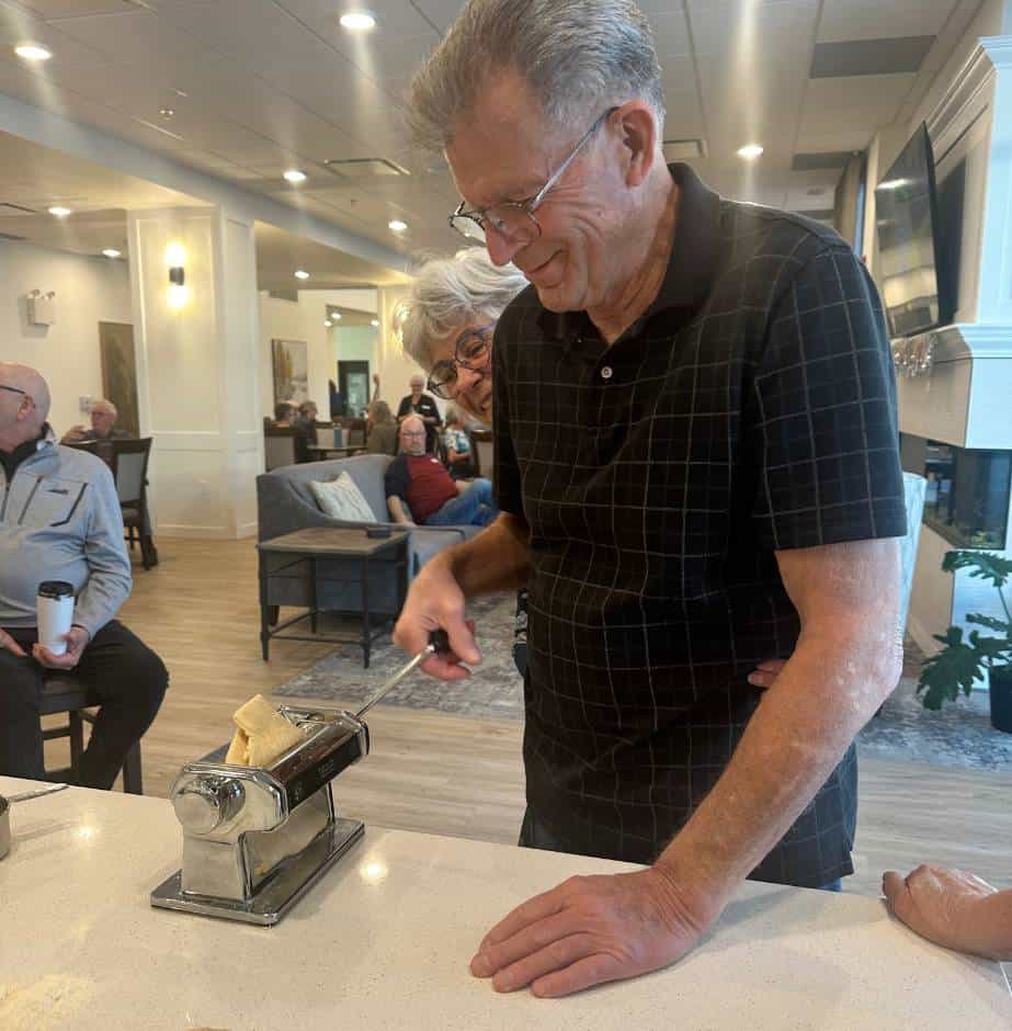 Man using a pasta maker in Three Robins Riverside Community Kitchen