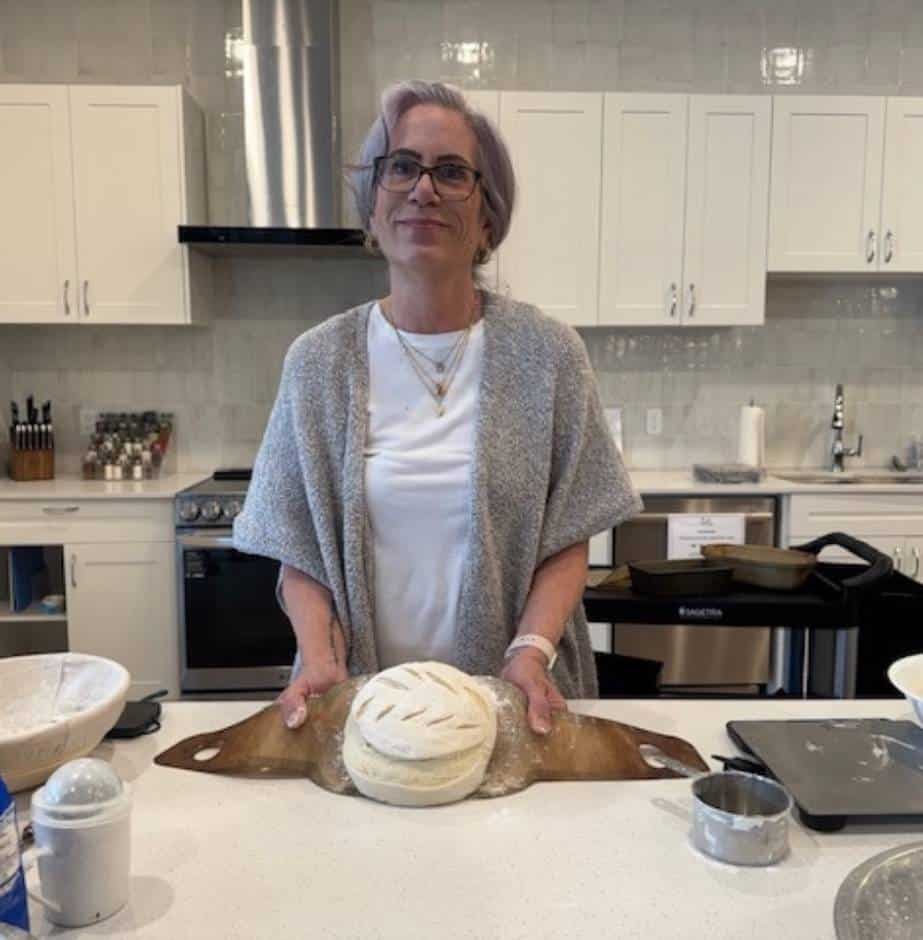 Person preparing sourdough bread at Three Robins Riverside.