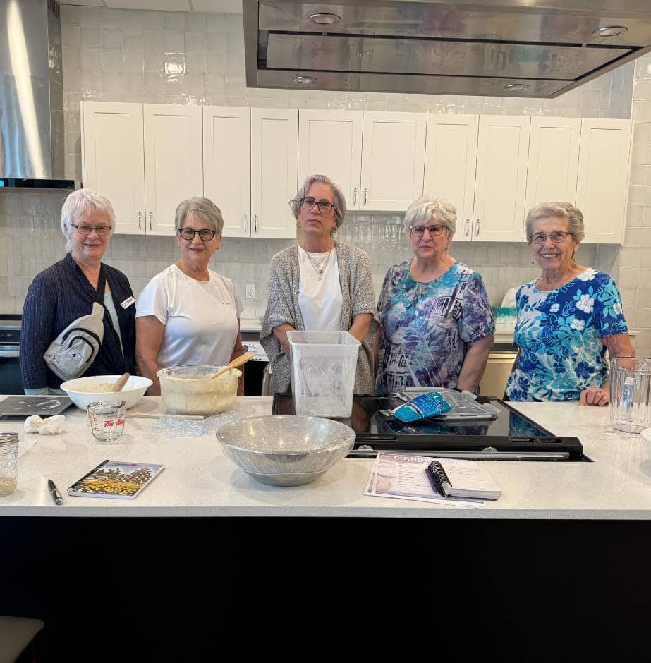 a group of residents making sour dough bread together