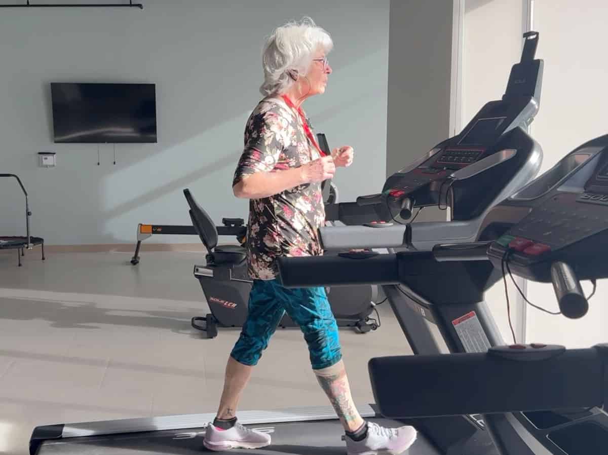 Three Robins Riverside resident jogging on a treadmill indoors.