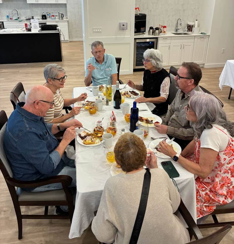 Residents sharing a meal together showing what active adult communities in St. Albert are like