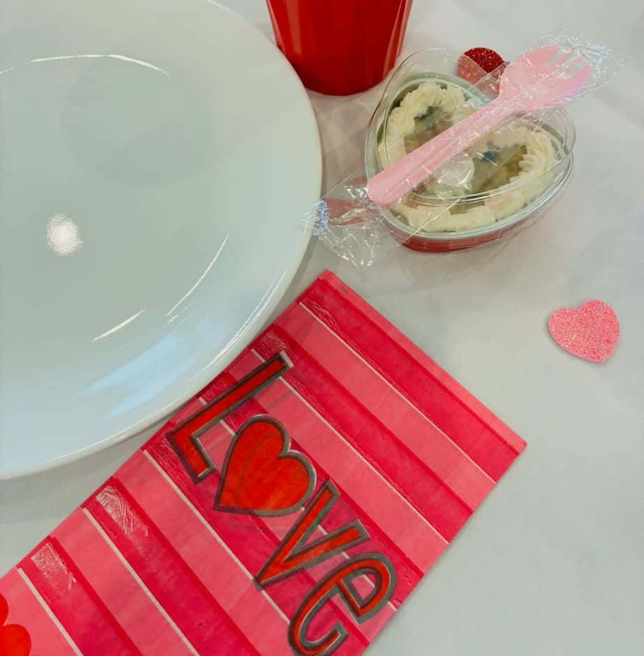 Table setting with love-themed decorations for Valentine's Day