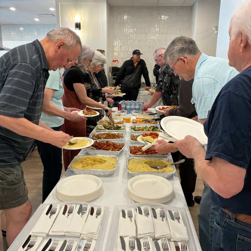 Three Robins Riverside Residence enjoying community meals