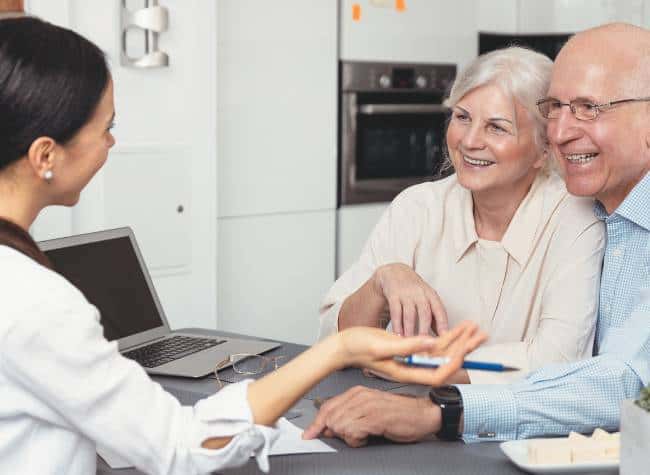 a senior couple using a support team to help transition to senior living and downsizing